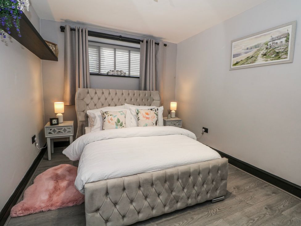 A bedroom with a bed and bedside tables at 2 Manor House farm Higher Ogden near Newhey