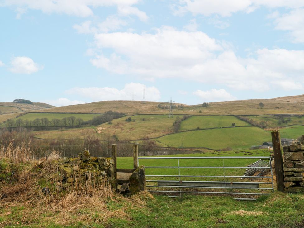 A view of a gate leading to a green field at 2 Manor House Farm in Higher Ogden near Newhey
