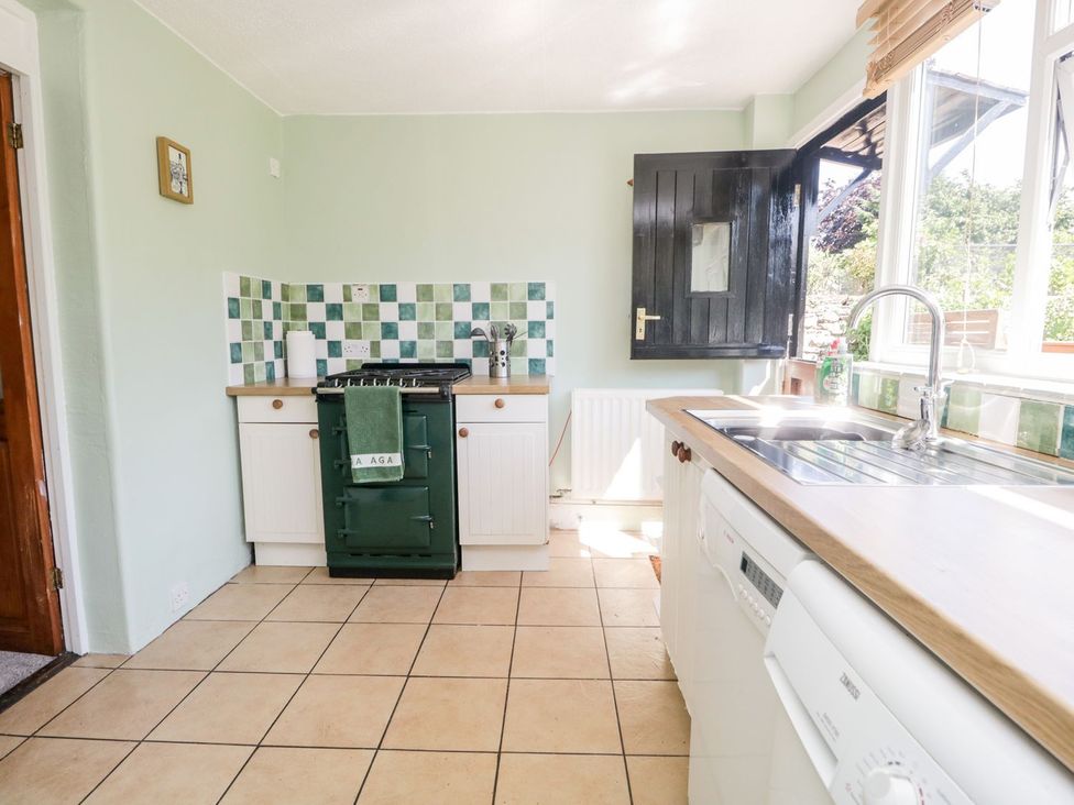 A kitchen with green tiles and an oven at Yewbarrow Seascale