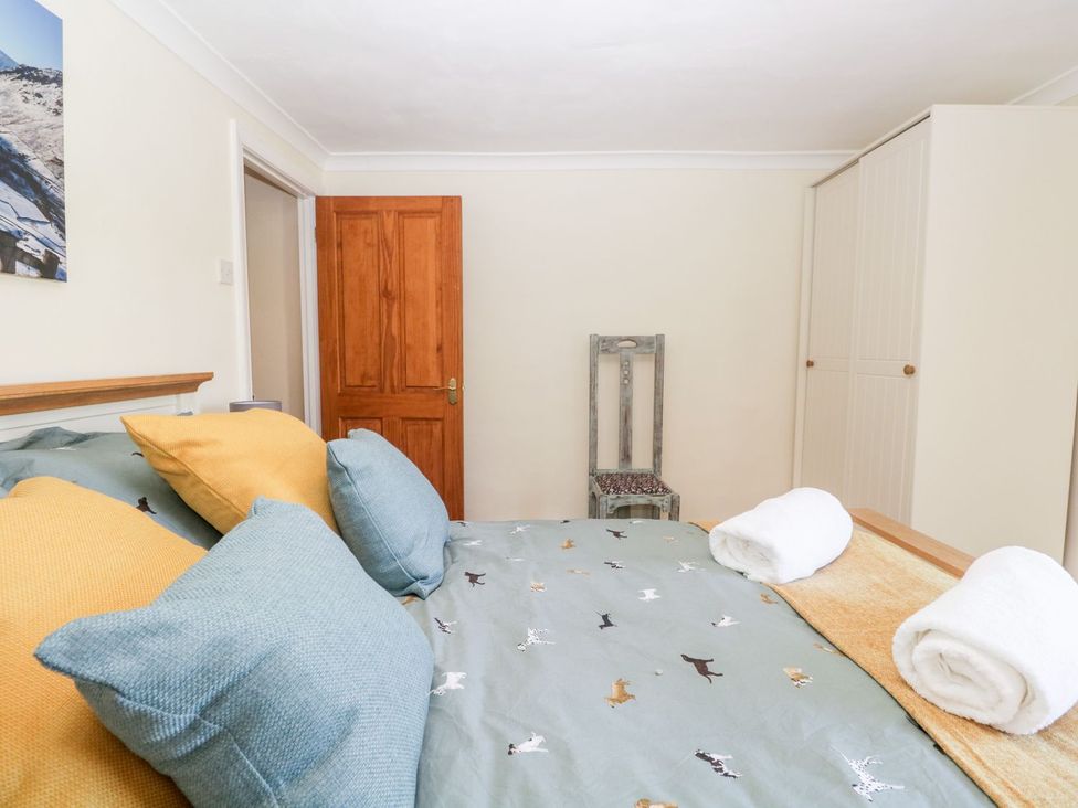 A bedroom with bed and chair at Yewbarrow in Seascale