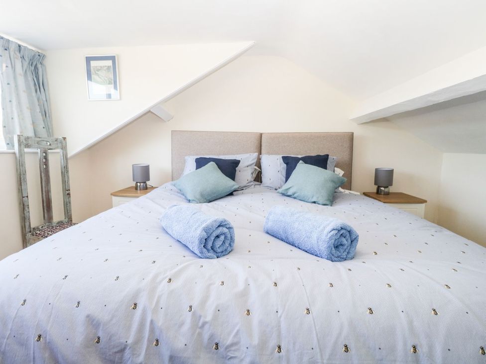A bedroom with a bed and side table at Yewbarrow in Seascale