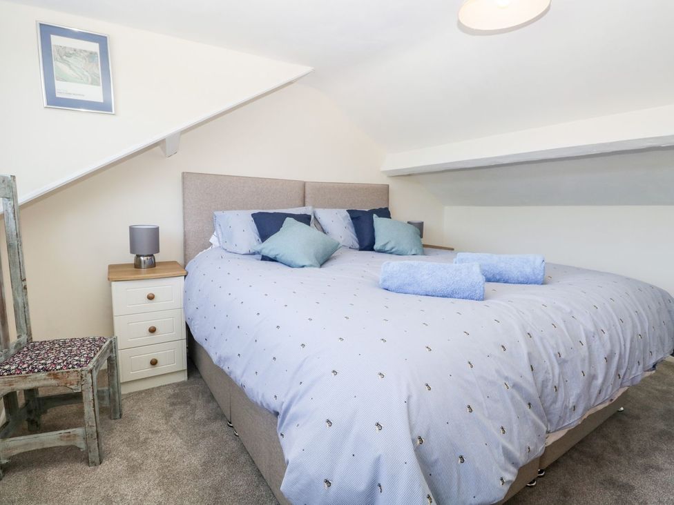 A bedroom with a bed and side furniture at Yewbarrow Seascale