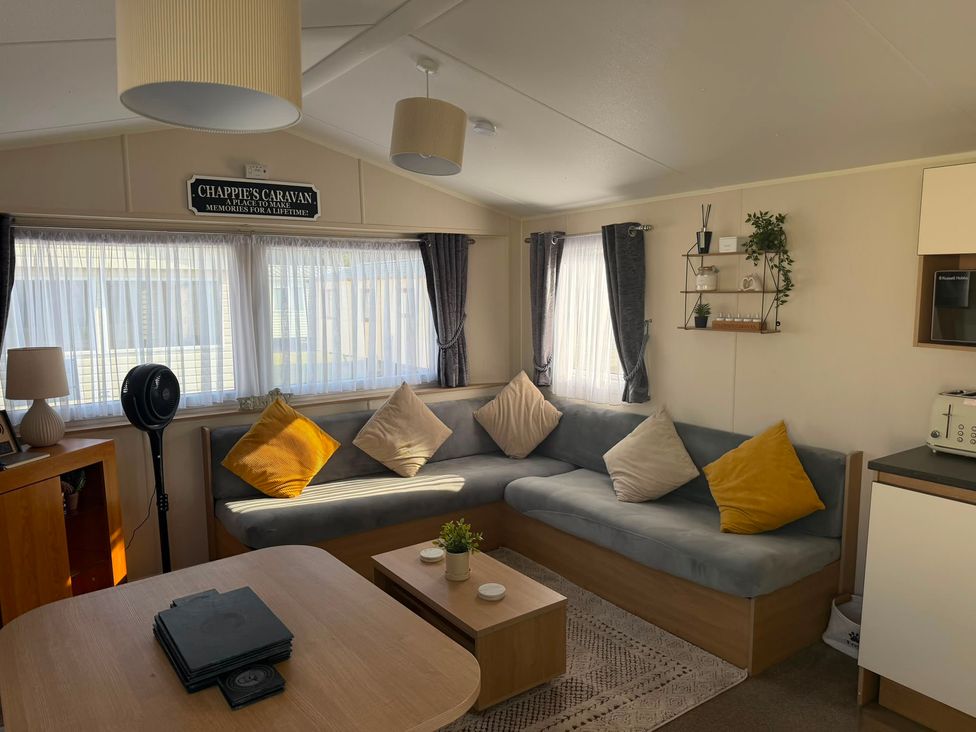 A living room with a sofa and coffee table at Chappie's Caravan 1.0 in Rhyl
