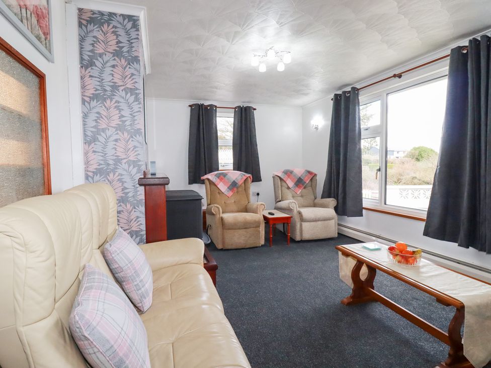 A living room with seating and a coffee table at The Bungalow in St. Austell