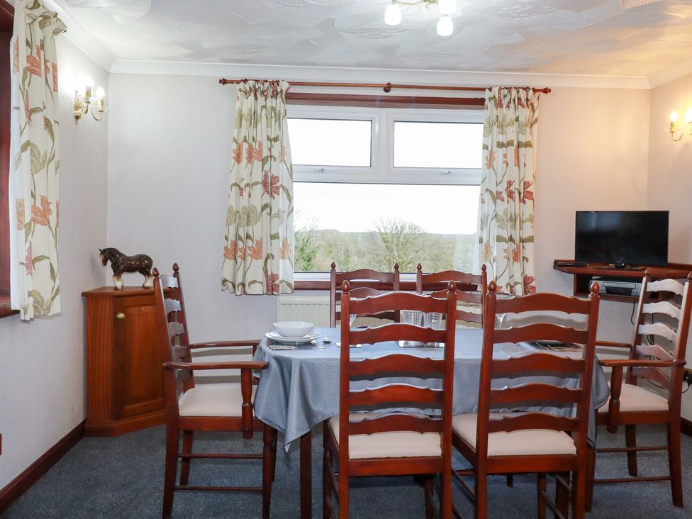 A dining room featuring a table and chairs at The Bungalow in St. Austell