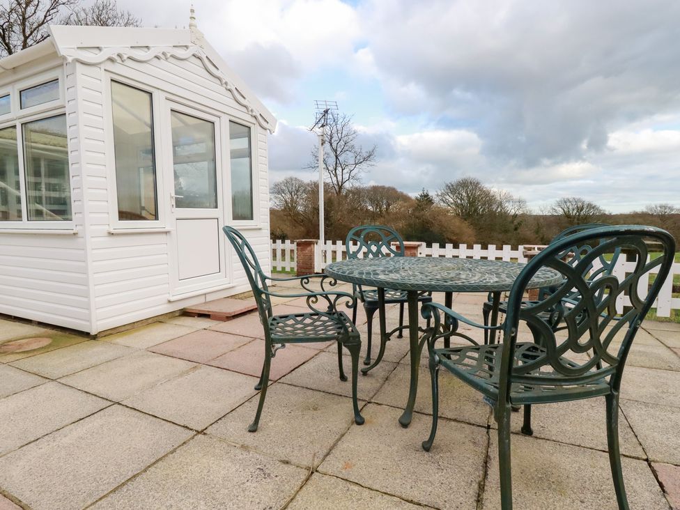 A conservatory and outdoor seating area at The Bungalow in St. Austell