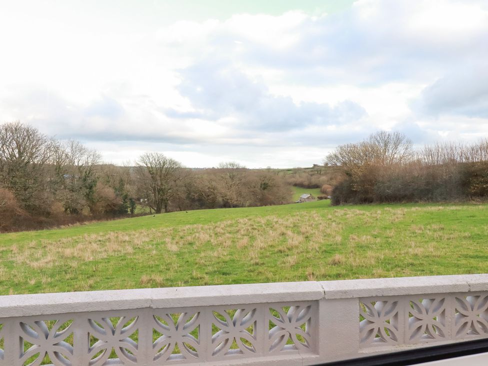 A view of a field and trees at The Bungalow in St. Austell