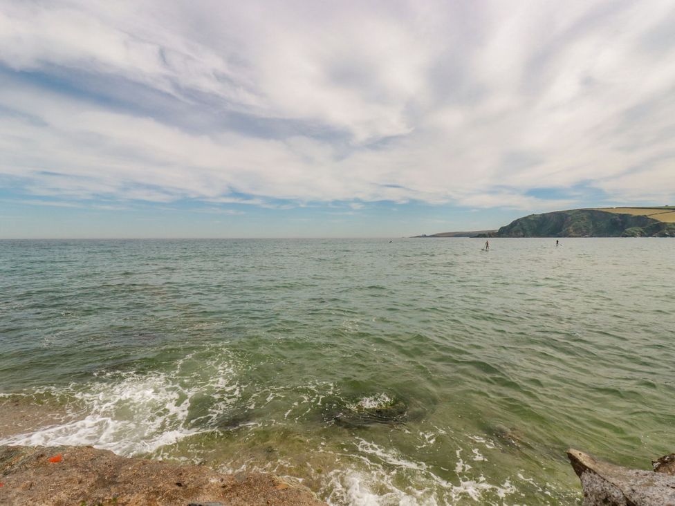A view of ocean and paddle boarders at The Bungalow in Polgooth