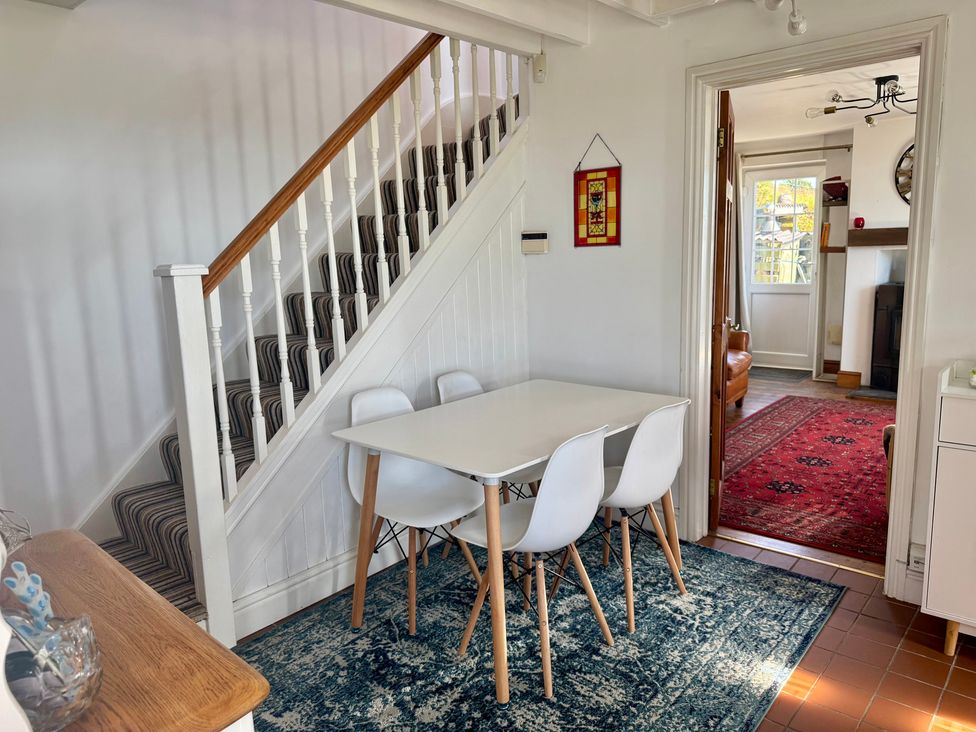 A dining room with a table and chairs at Penpegws near Aberystwyth