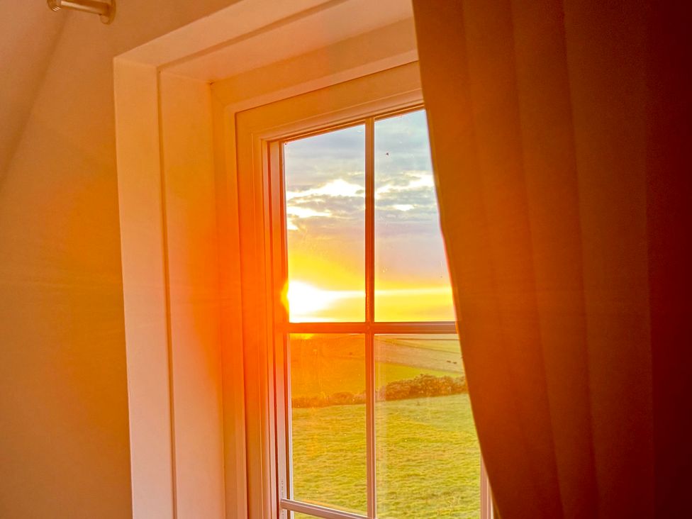 A window with a sunset view at Penpegws near Aberystwyth