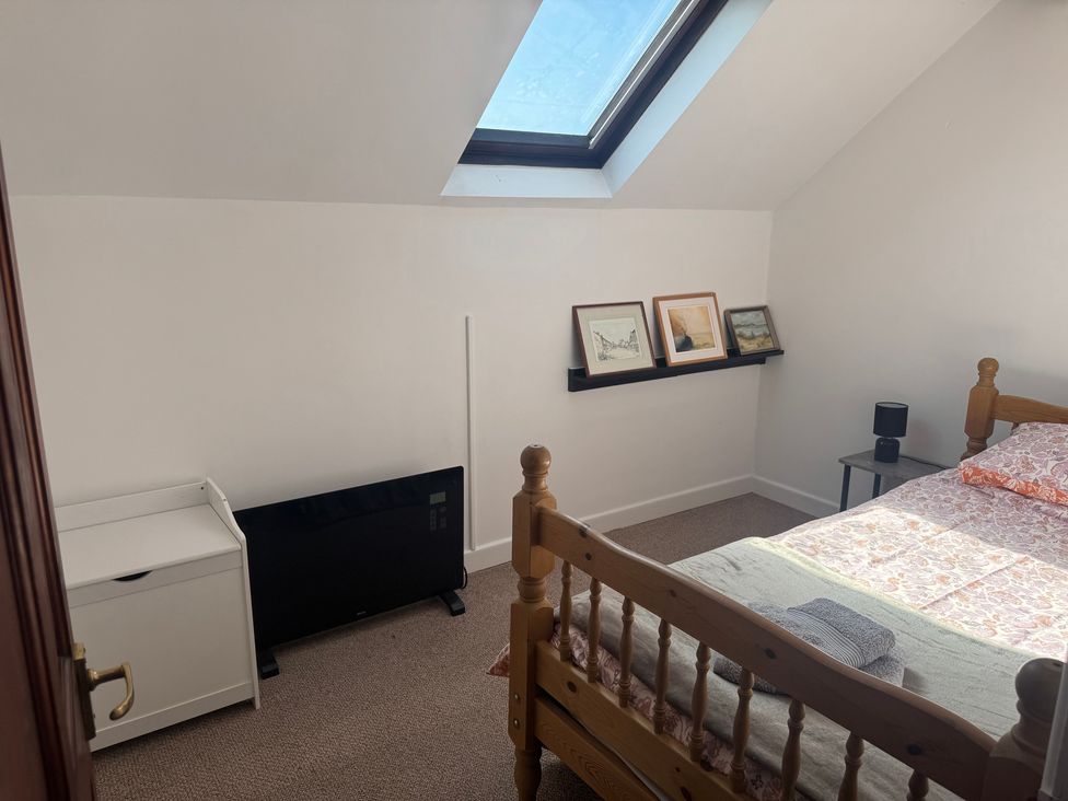 A bedroom with a bed and television at Penpegws near Aberystwyth