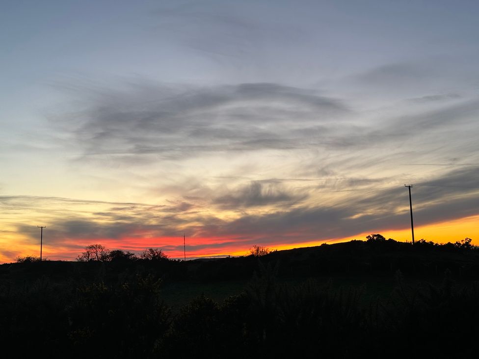 A sunset with clouds and hills at Penpegws near Aberystwyth