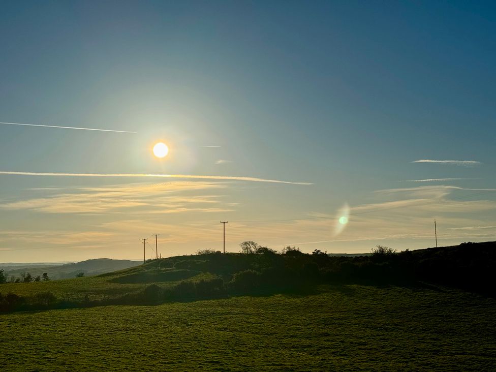 A landscape view featuring sun and hills at Penpegws near Aberystwyth