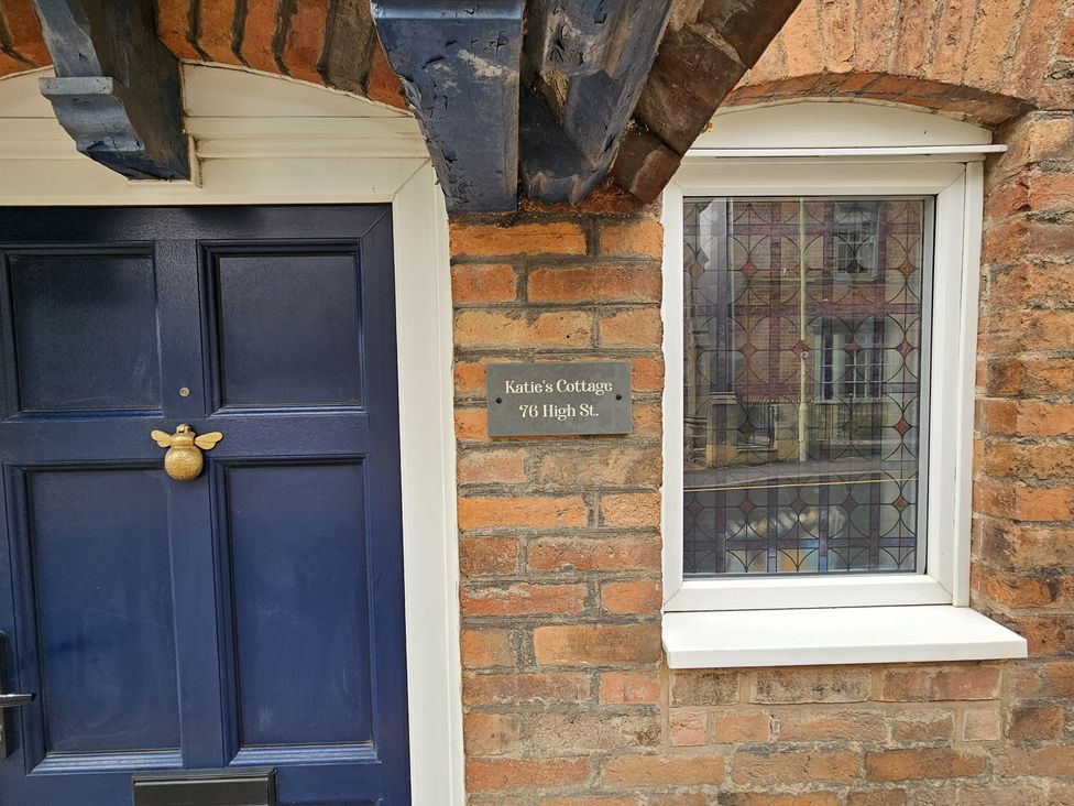 An entrance with a blue door and a window at Katie's Cottage in Church Stretton