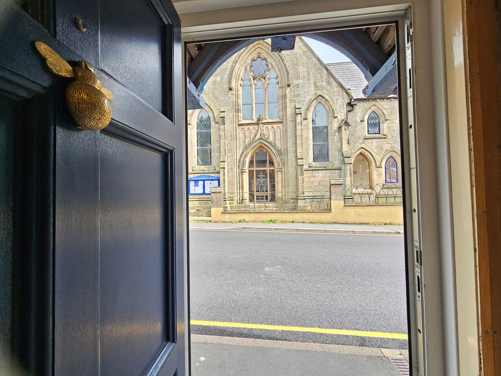 A view from the entrance door to a church across the street at Katie's Cottage in Church Stretton