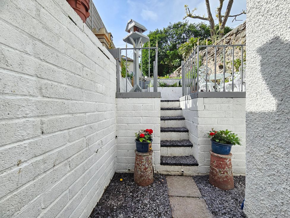 A garden with stairs and planters at Katie's Cottage in Church Stretton