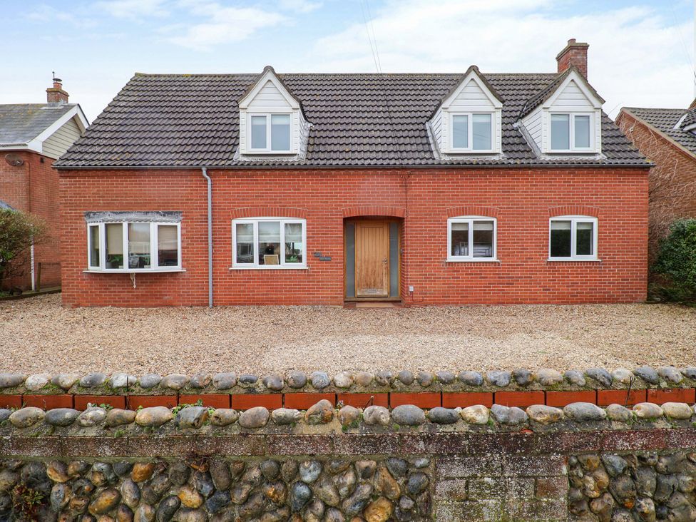 A house with windows and a door at Cliff Cottage