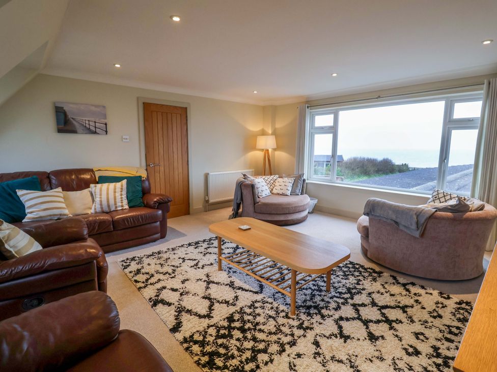 A living room with sofas and a coffee table at Cliff Cottage