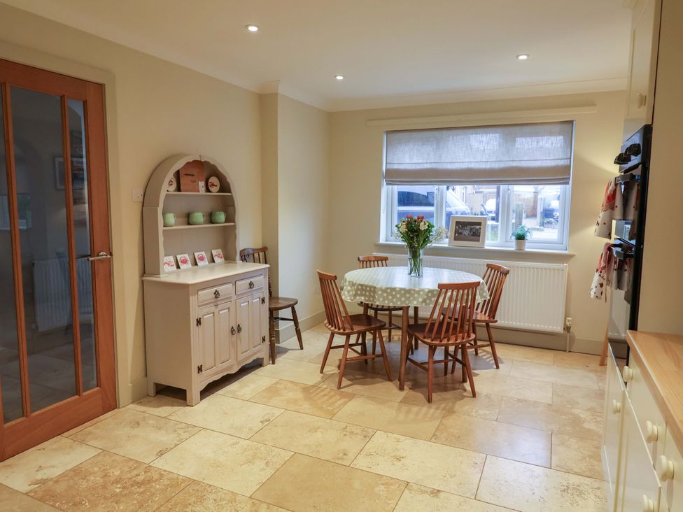 A kitchen with a dining table and chairs at Cliff Cottage