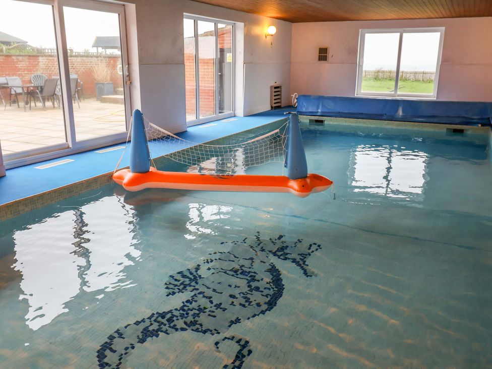 An indoor swimming pool with a pool float at Cliff Cottage