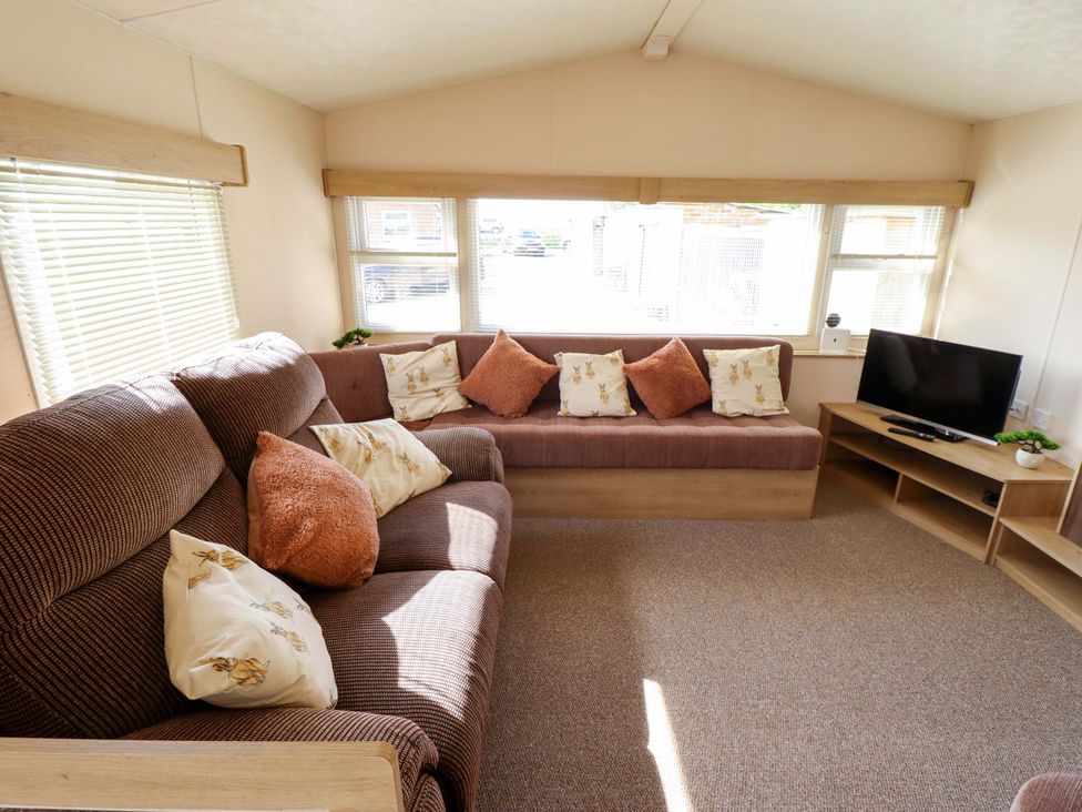 A living room with a sofa and television at Ewe View