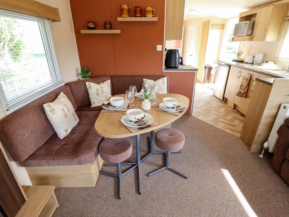 A dining area with a table set for meals at Ewe View