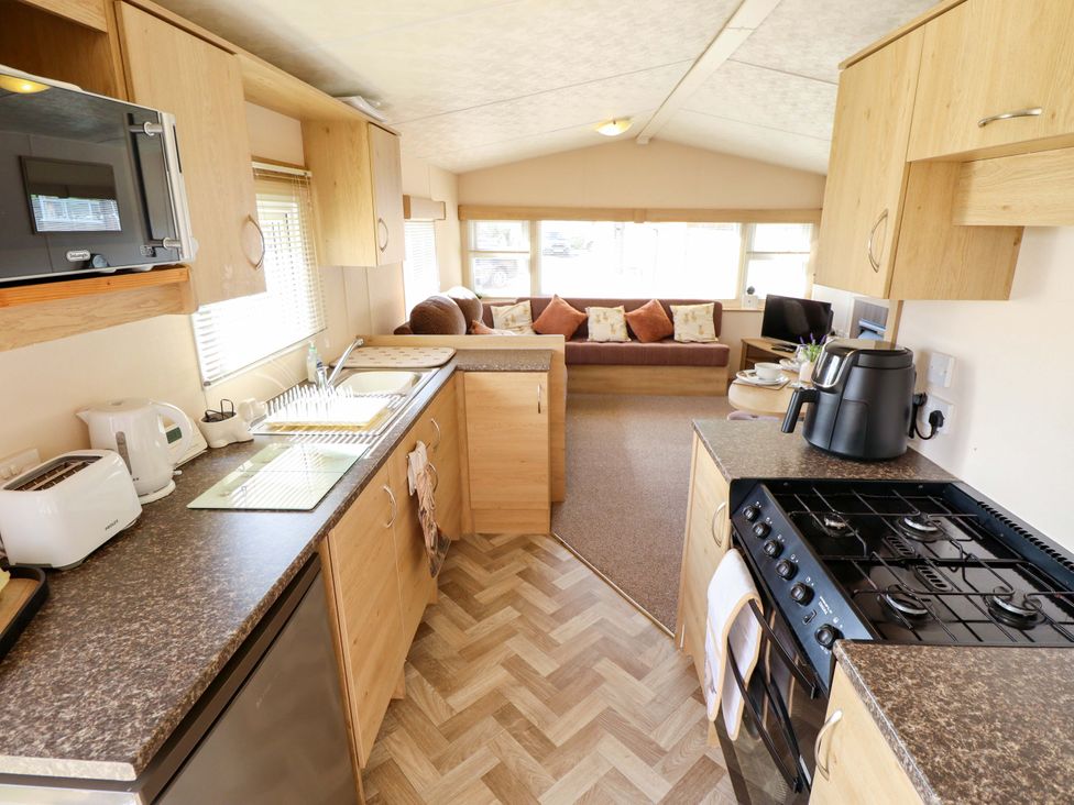 A kitchen with appliances and a couch at Ewe View