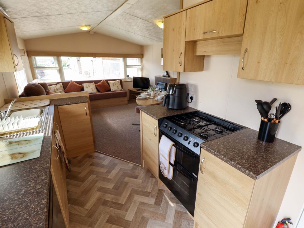 A kitchen with a gas stove and sink at Ewe View