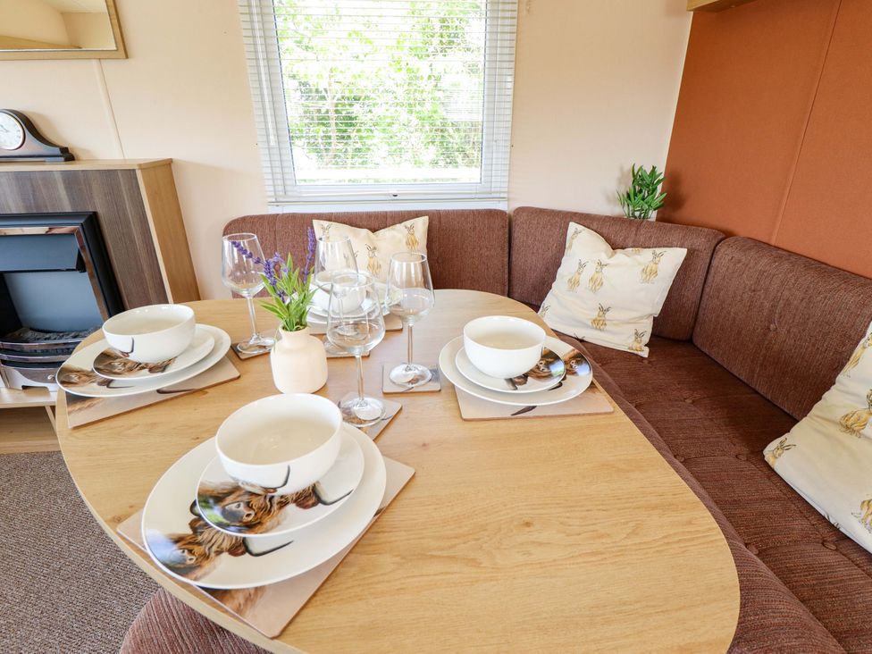 A dining table set with dishes and glasses at Ewe View