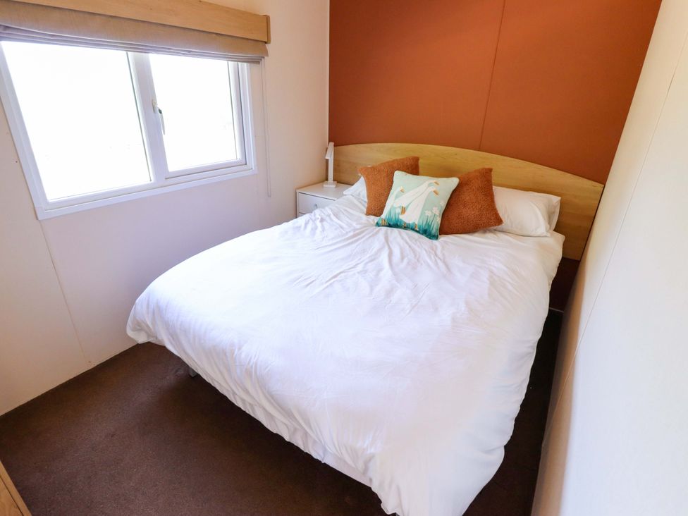 A bedroom with a bed and a window at Ewe View