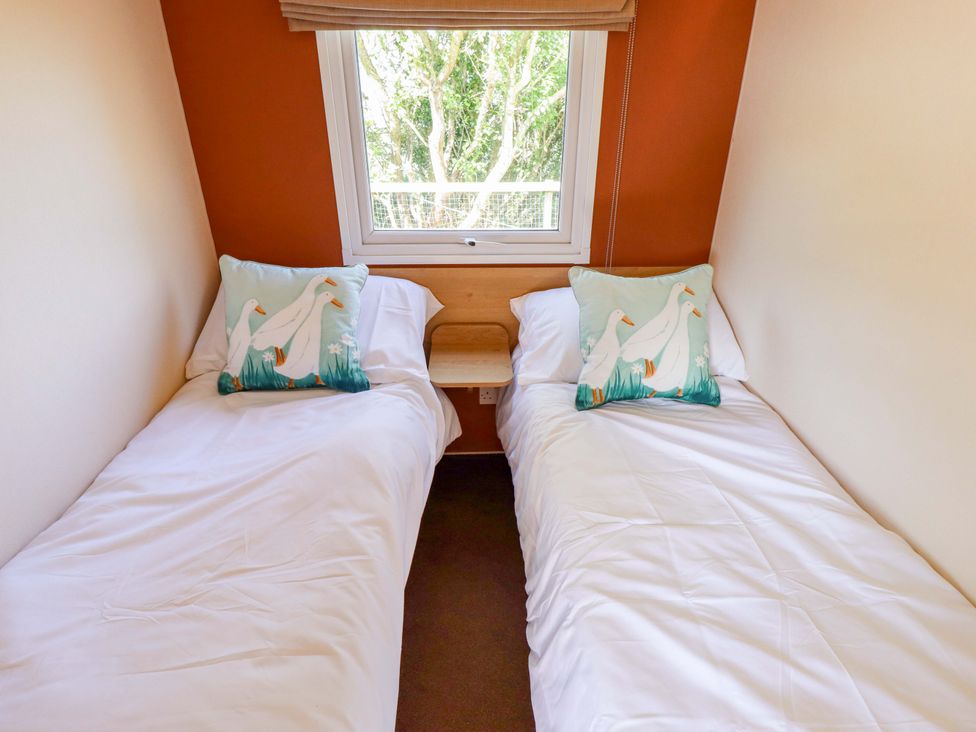 A bedroom with two beds and a window at Ewe View 