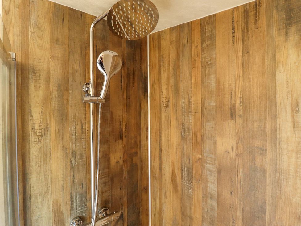 A shower with a showerhead and handheld shower in a bathroom at Ewe View