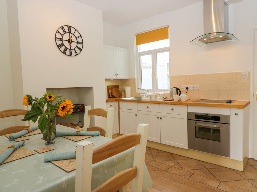 A kitchen with a table and chairs at 8 Railway Cottages in Ulverston
