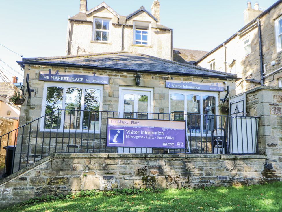 A building with signage for a visitor information center at Dove Cottage in Hexham