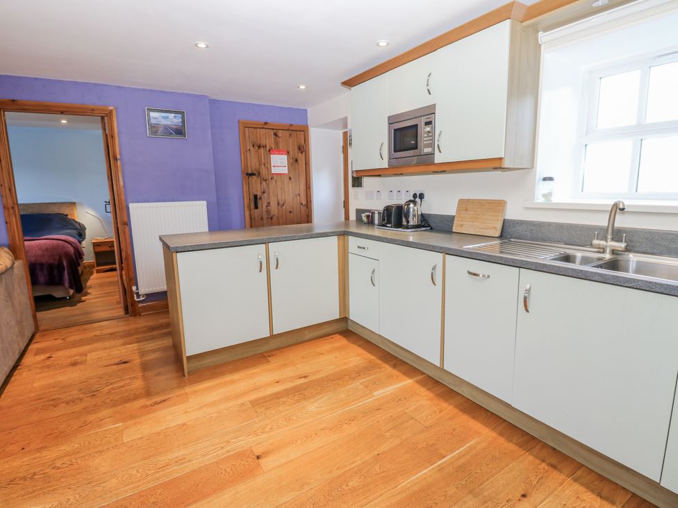 A kitchen with cabinets and appliances at Swallows Rest in Hexham