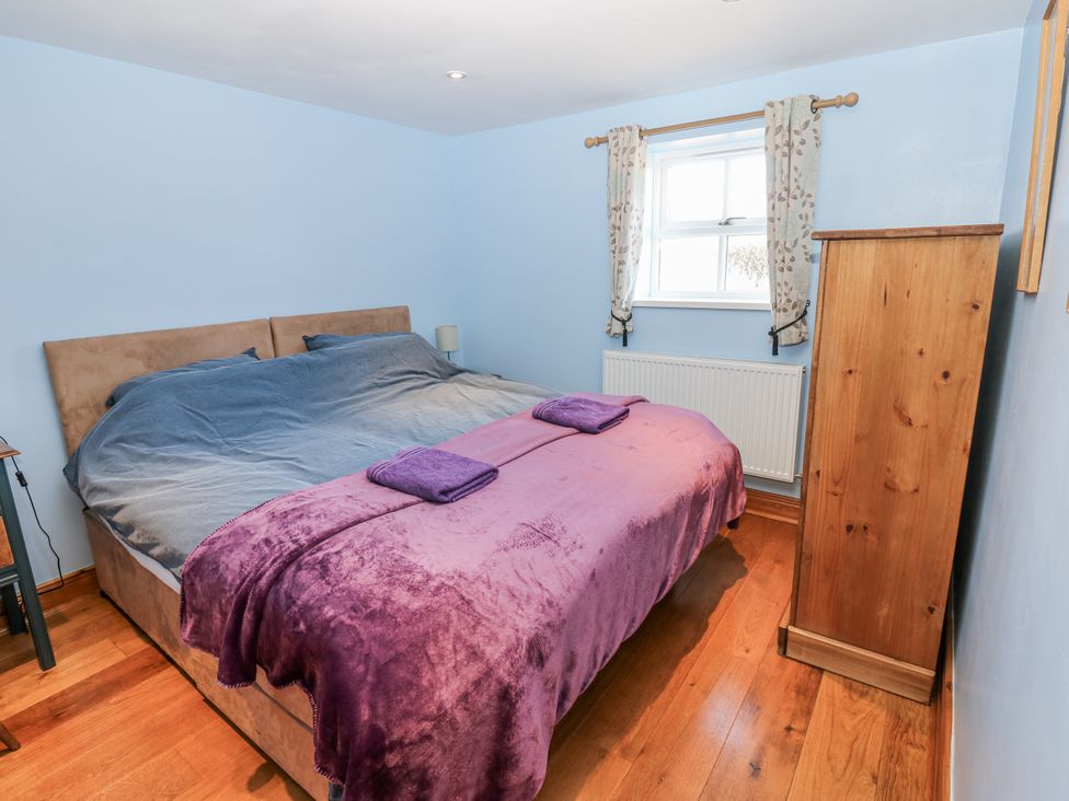 A bedroom featuring a bed with blankets and towels at Swallows Rest in Hexham