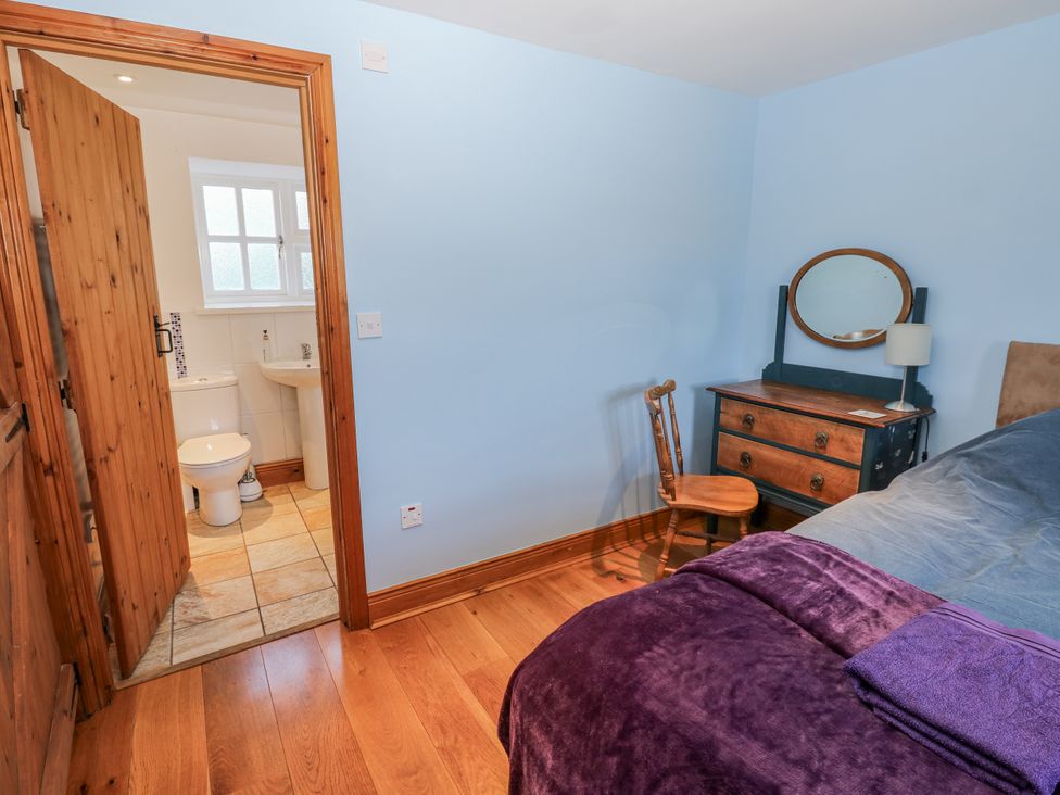 A bedroom with a bed and vanity table at Swallows Rest in Hexham