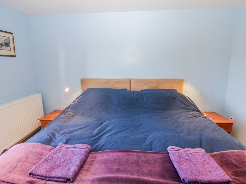 A bedroom with a bed and towels at Swallows Rest in Hexham