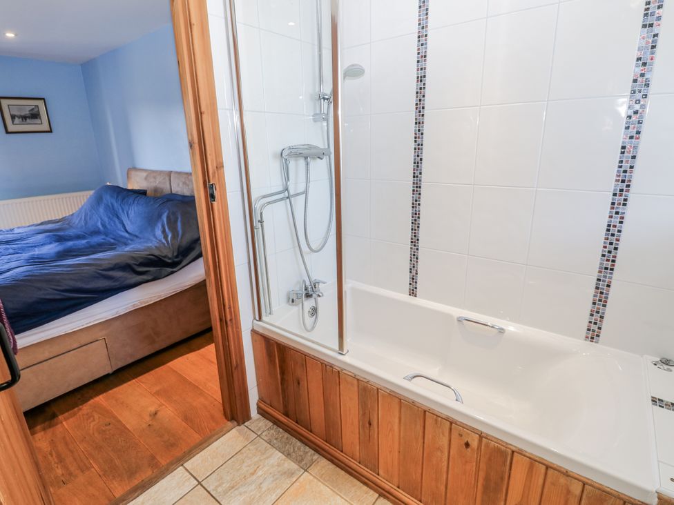 A bathroom with a shower and bathtub visible at Swallows Rest in Hexham