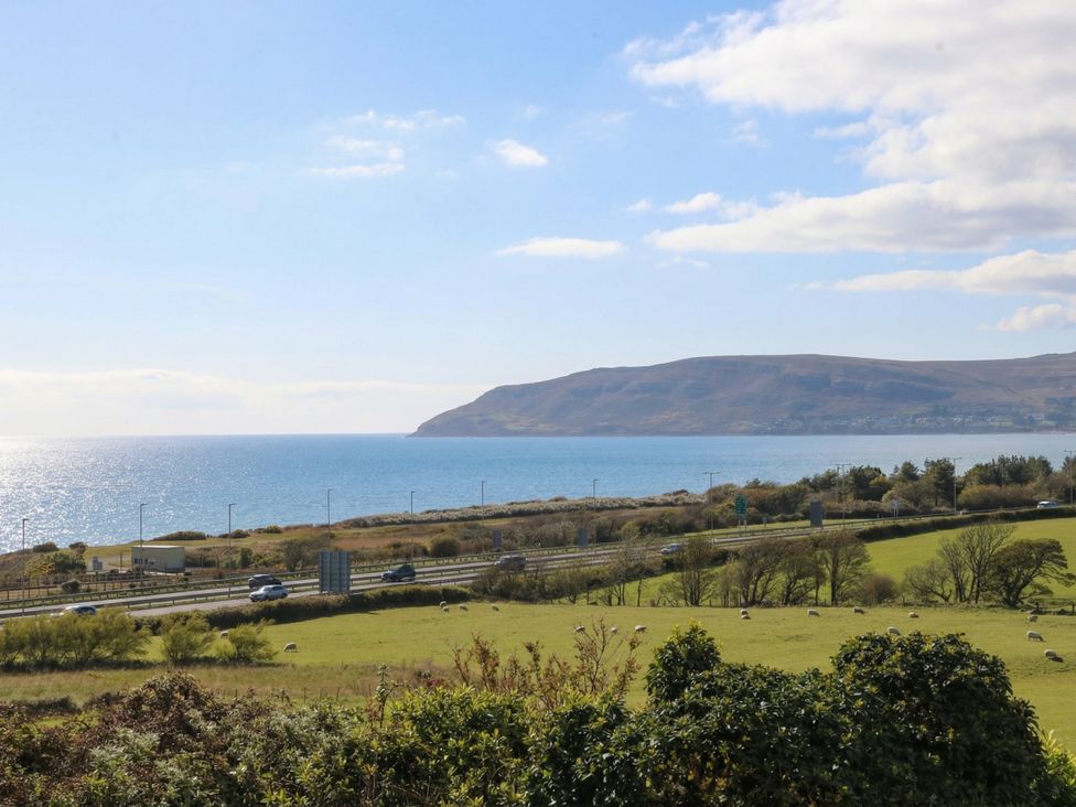 A coastal view with a road and hills at Orme View in Penmaenmawr