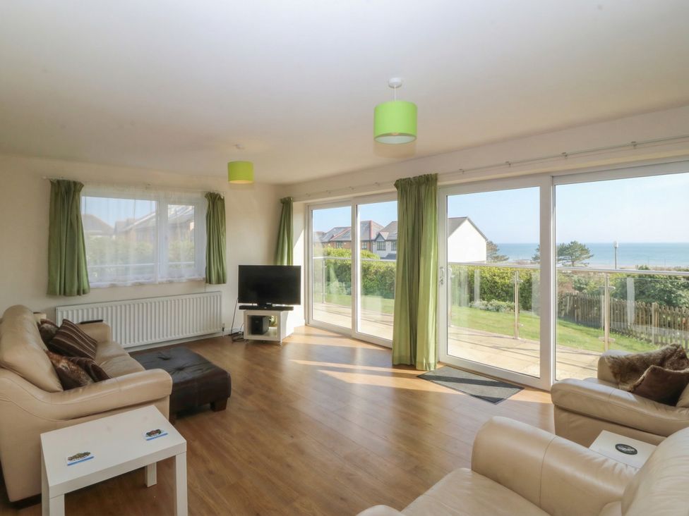 A living room with a sofa and TV at Orme View in Penmaenmawr