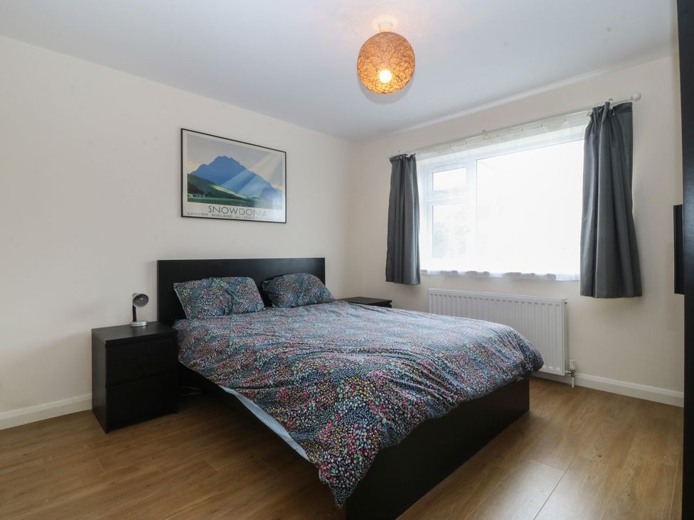 A bedroom with a bed and nightstand at Orme View in Penmaenmawr