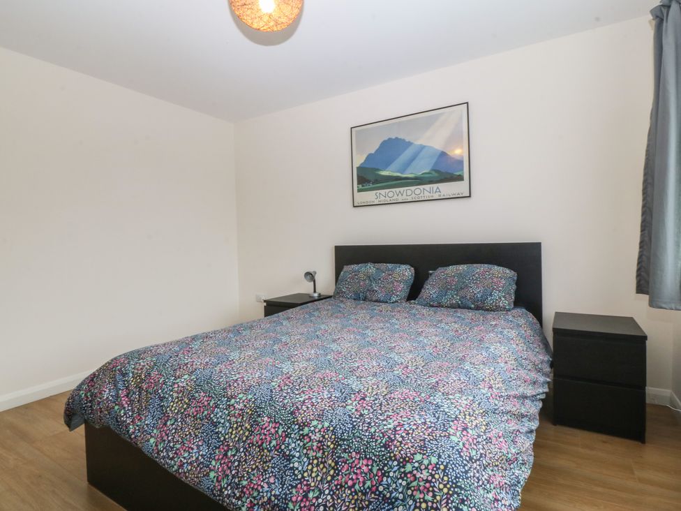 A bedroom with a bed and nightstand at Orme View in Penmaenmawr
