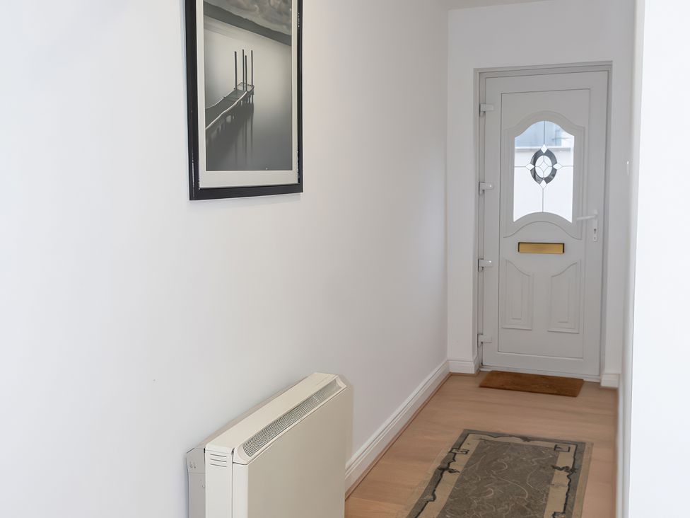 A hallway with a door and a photo at Enniskillen hideaway in Enniskillen