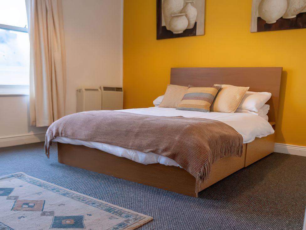 A bedroom with a bed and artwork on the wall at Enniskillen hideaway in Enniskillen