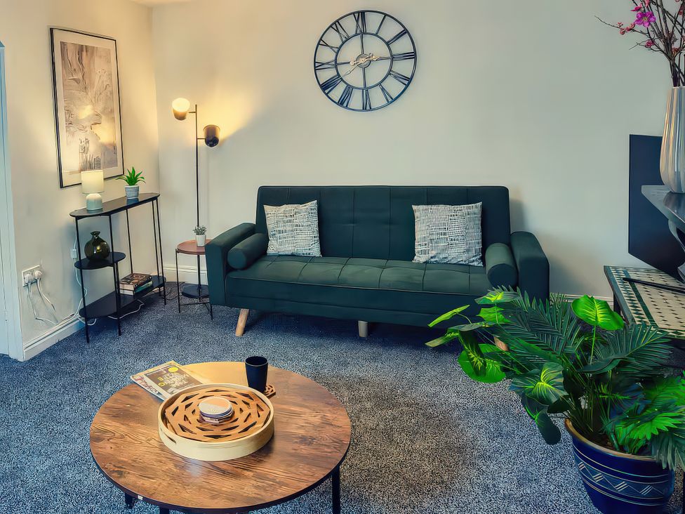 A living room with a sofa and coffee table at 20 Bridge Street in Morpeth