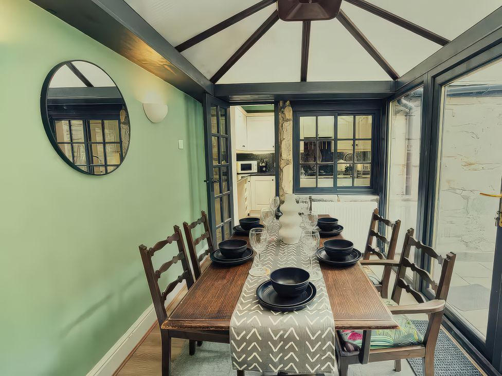 A dining room with a table and chairs at 20 Bridge Street in Morpeth