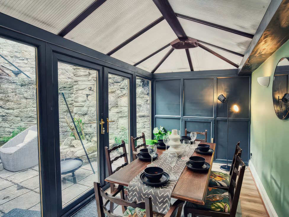 A dining setup with a table and chairs in a conservatory at 20 Bridge Street Morpeth
