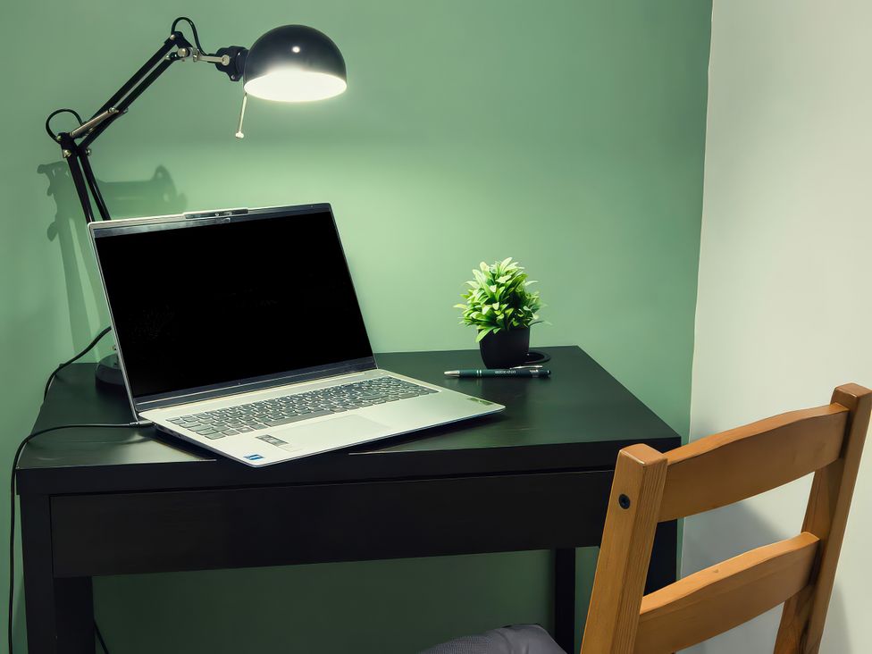 An office with a laptop and desk lamp at 20 Bridge Street in Morpeth