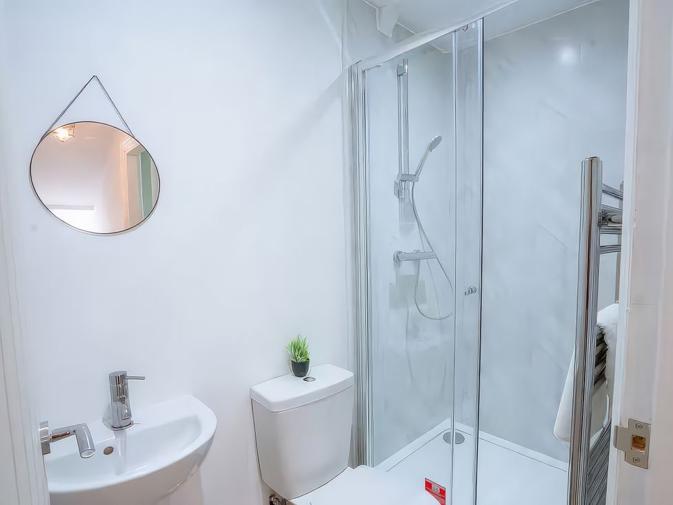 A bathroom with a shower, sink, and toilet at 20 Bridge Street in Morpeth